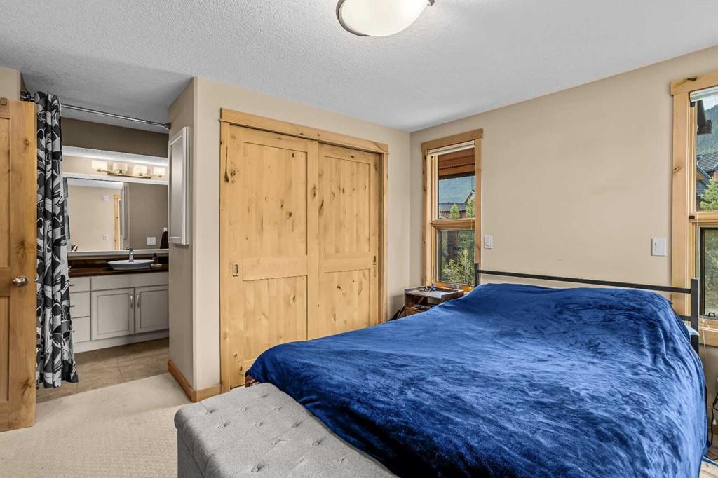 302-2100A Stewart Creek Drive, Canmore, AB - Indoor Photo Showing Bedroom