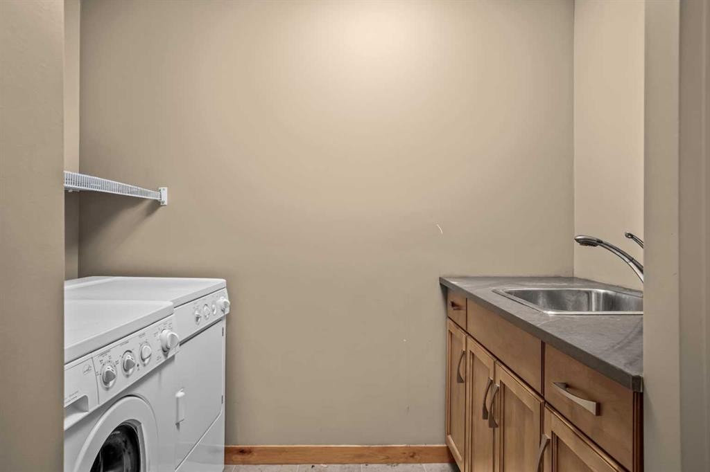 302-2100A Stewart Creek Drive, Canmore, AB - Indoor Photo Showing Laundry Room