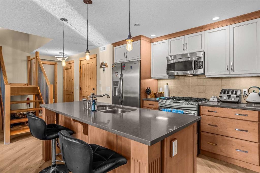 302-2100A Stewart Creek Drive, Canmore, AB - Indoor Photo Showing Kitchen With Double Sink With Upgraded Kitchen