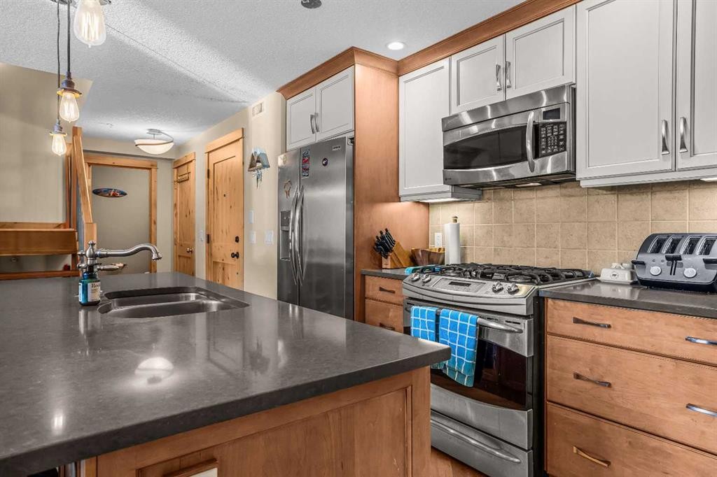 302-2100A Stewart Creek Drive, Canmore, AB - Indoor Photo Showing Kitchen With Double Sink