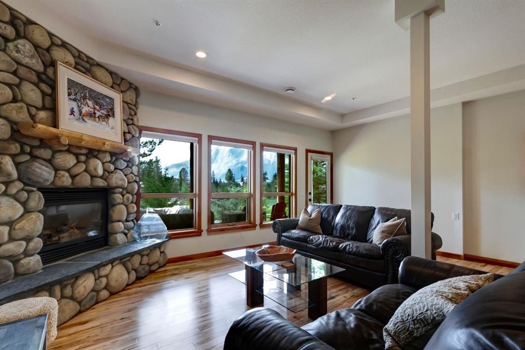 25-300 Eagle Terrace Road, Canmore, AB - Indoor Photo Showing Living Room With Fireplace