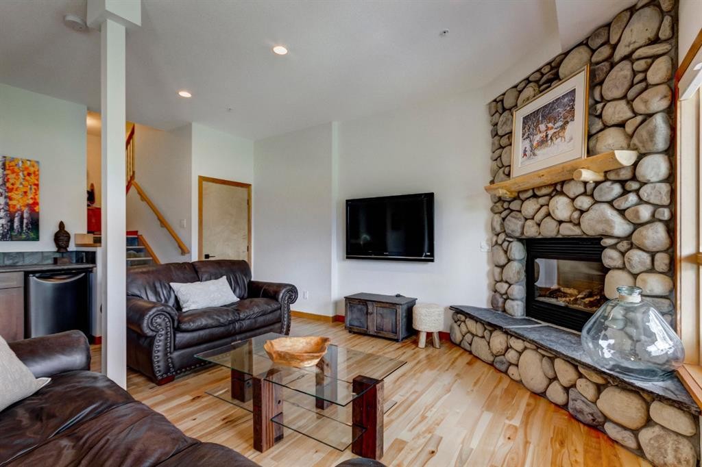25-300 Eagle Terrace Road, Canmore, AB - Indoor Photo Showing Living Room With Fireplace