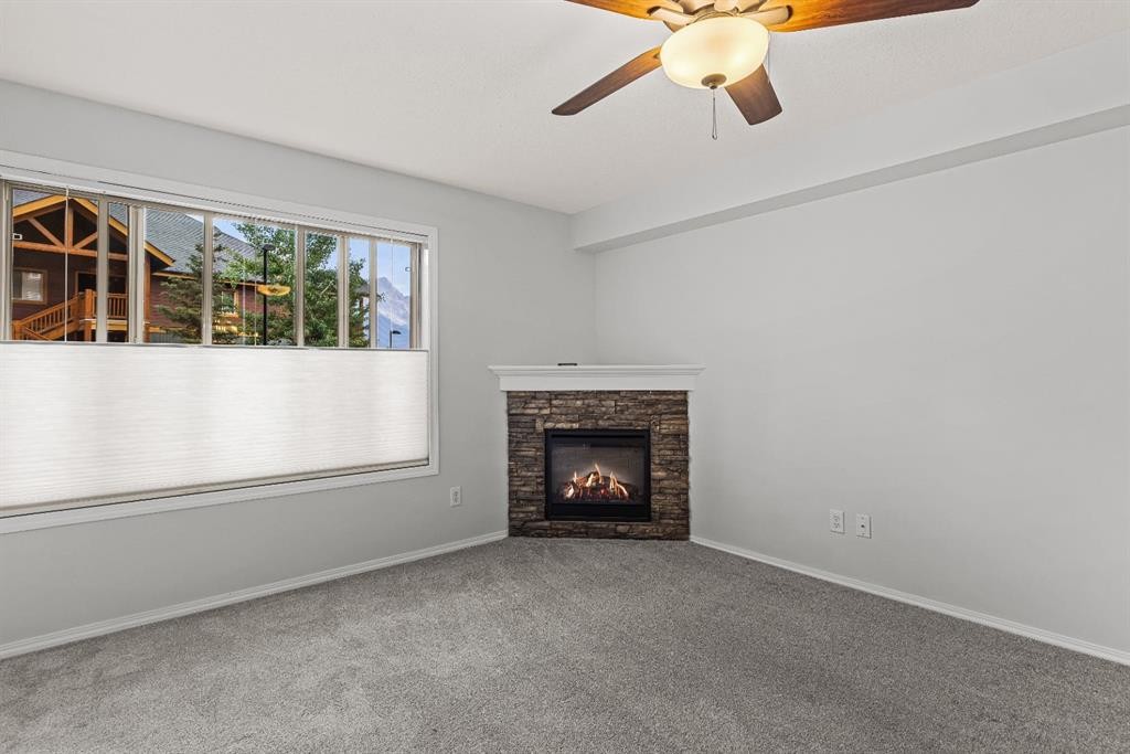 120-300 Palliser Lane, Canmore, AB - Indoor Photo Showing Living Room With Fireplace