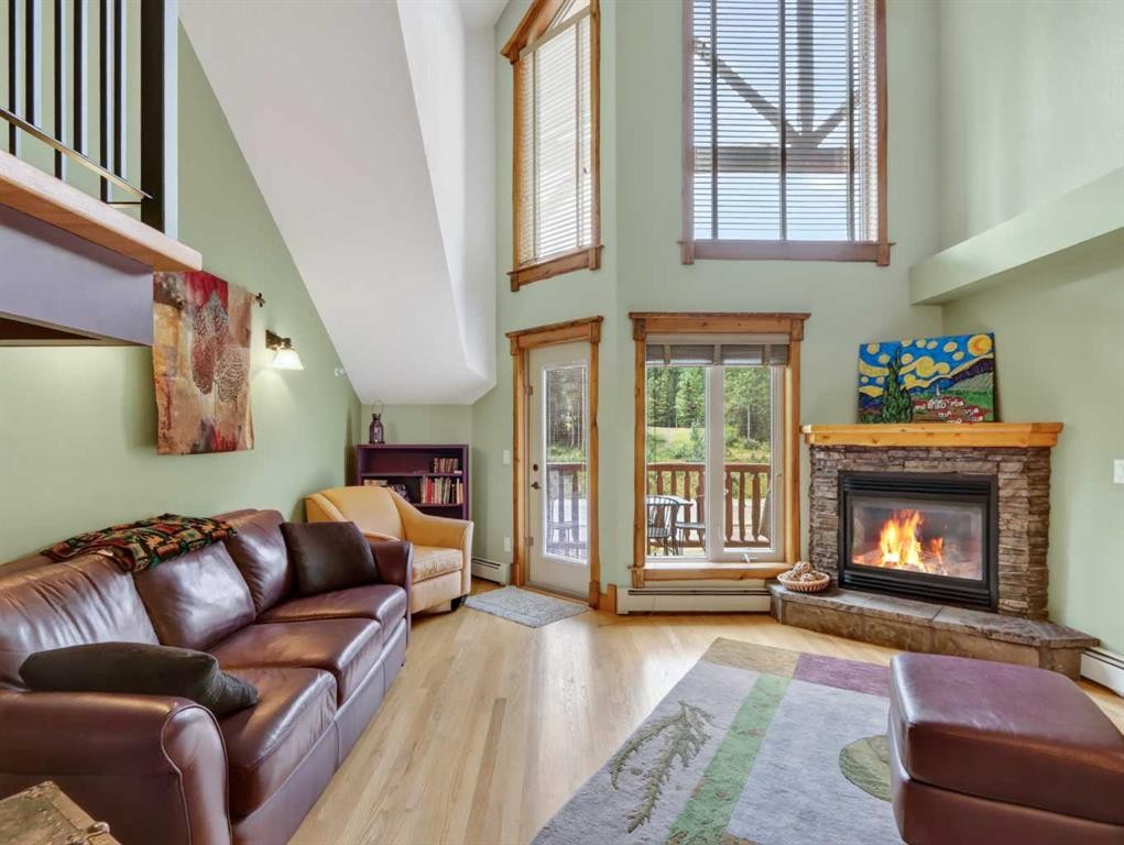 307-155 Crossbow Place, Canmore, AB - Indoor Photo Showing Living Room With Fireplace