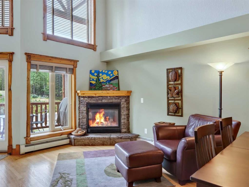 307-155 Crossbow Place, Canmore, AB - Indoor Photo Showing Living Room With Fireplace
