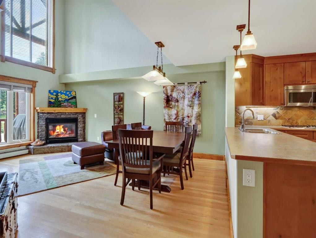 307-155 Crossbow Place, Canmore, AB - Indoor Photo Showing Dining Room With Fireplace