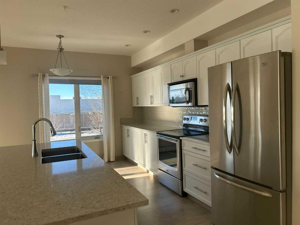 202-4403 67A Avenue, Olds, AB - Indoor Photo Showing Kitchen With Double Sink