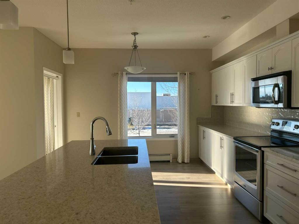 202-4403 67A Avenue, Olds, AB - Indoor Photo Showing Kitchen With Double Sink