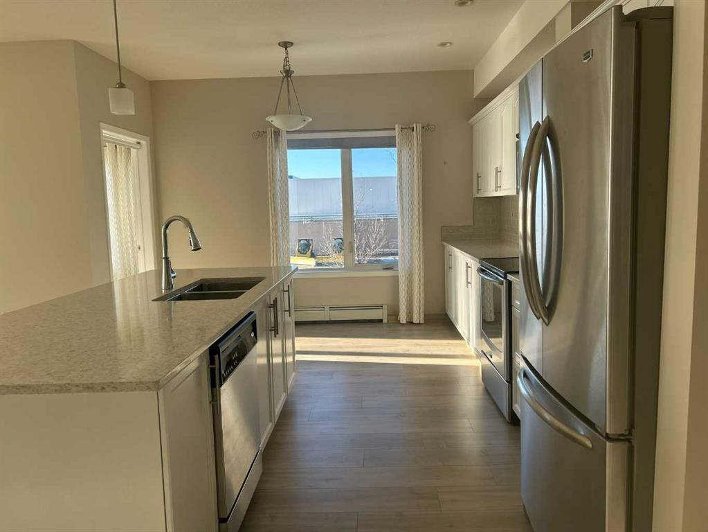 202-4403 67A Avenue, Olds, AB - Indoor Photo Showing Kitchen With Double Sink