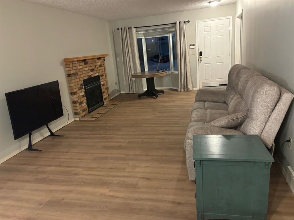 32 Ramsey Close, Red Deer, AB - Indoor Photo Showing Living Room With Fireplace