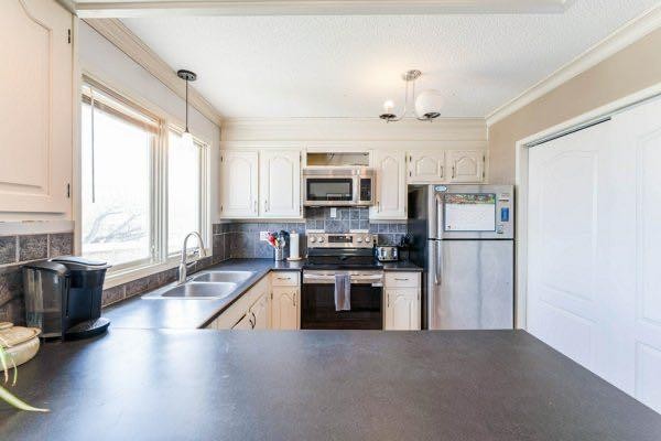 25 Park Place, Drumheller, AB - Indoor Photo Showing Kitchen With Double Sink