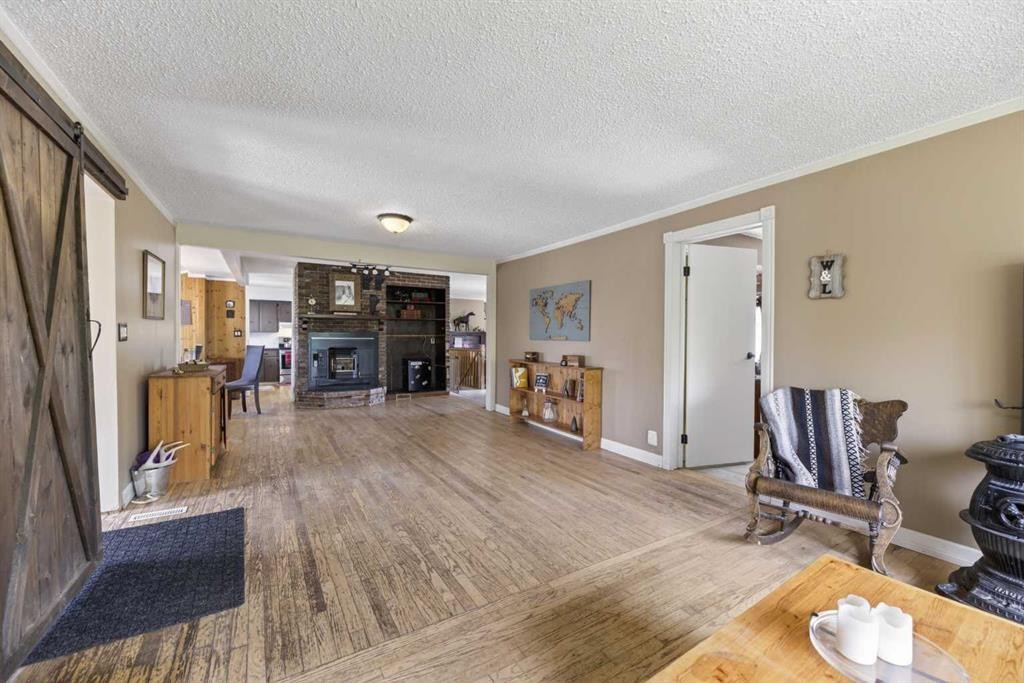 Highway 791, Rural Mountain View County, AB - Indoor Photo Showing Living Room With Fireplace