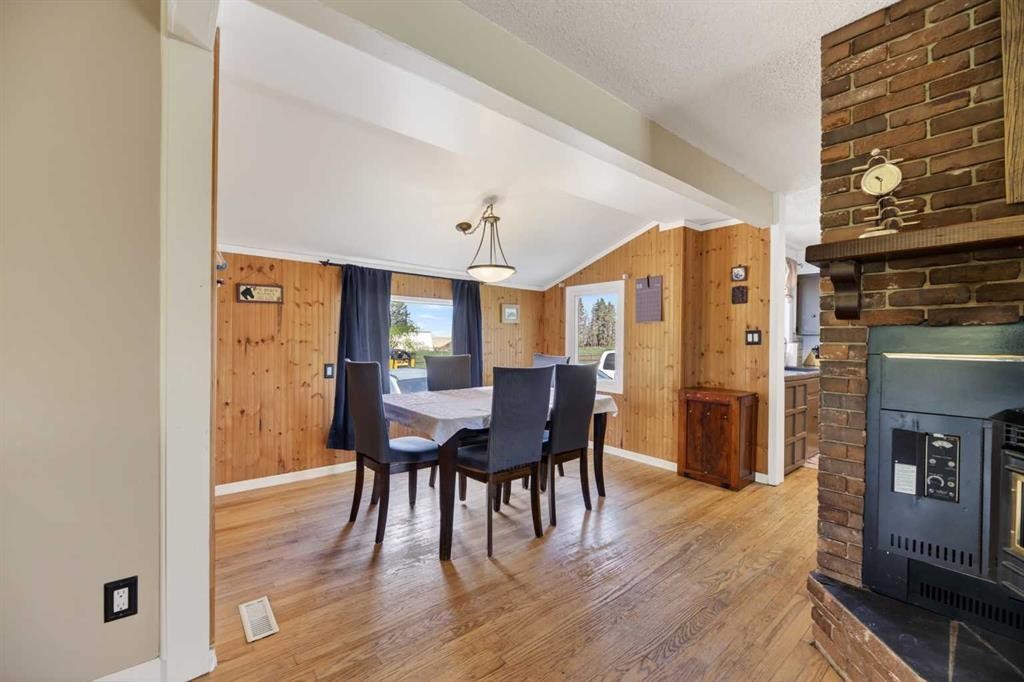 Highway 791, Rural Mountain View County, AB - Indoor Photo Showing Dining Room With Fireplace