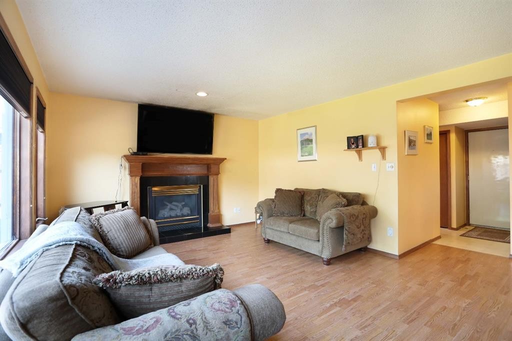 35 Parkland Close East, Brooks, AB - Indoor Photo Showing Living Room With Fireplace