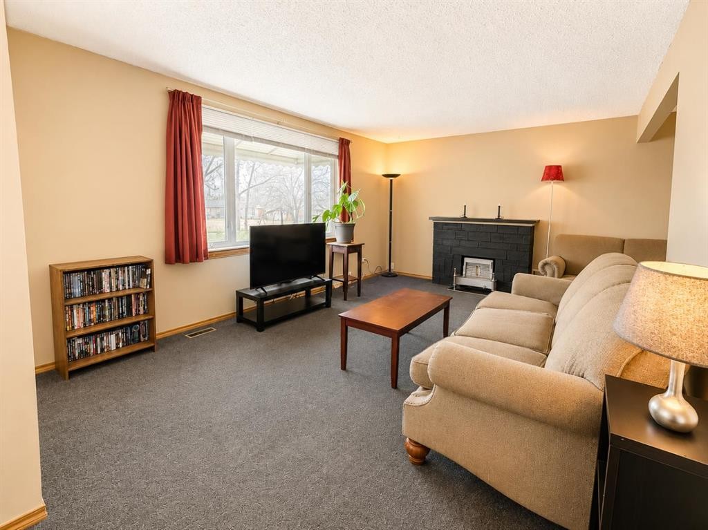 614 6 Avenue, Wainwright, AB - Indoor Photo Showing Living Room With Fireplace