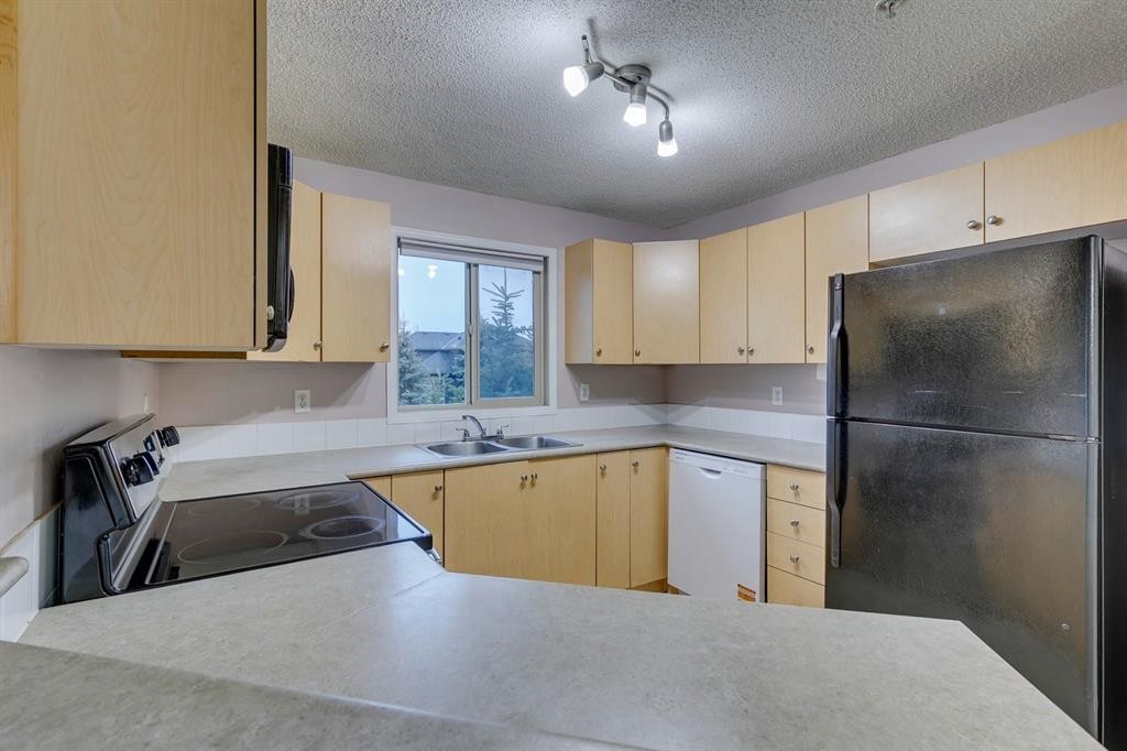 1202-16969 24 Street Sw, Calgary, AB - Indoor Photo Showing Kitchen With Double Sink