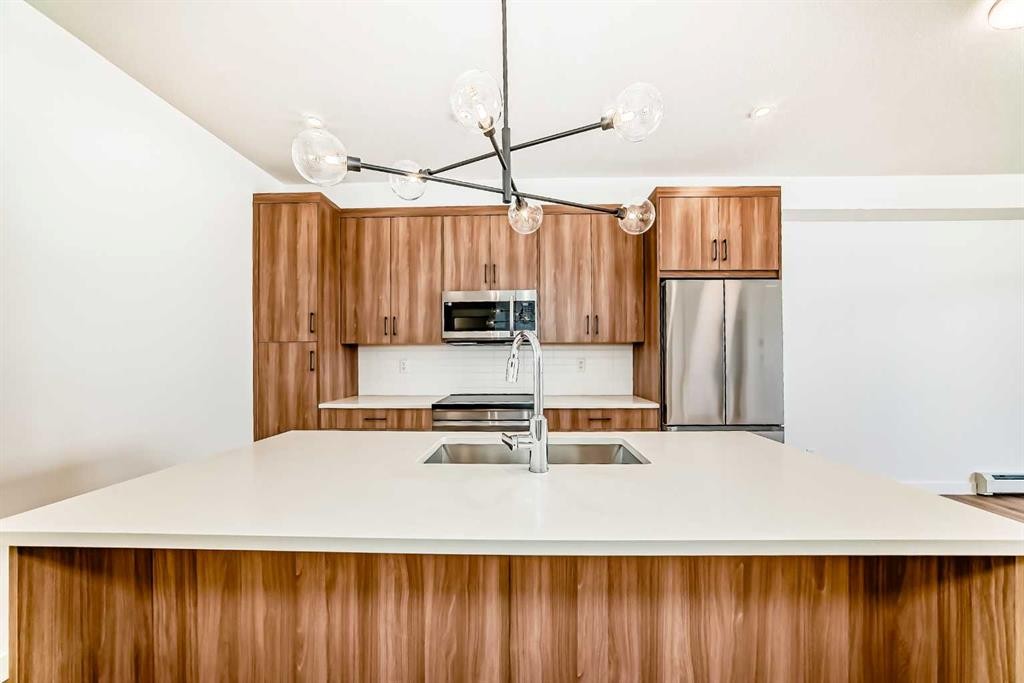 8202-1802 Mahogany Boulevard Se, Calgary, AB - Indoor Photo Showing Kitchen With Stainless Steel Kitchen With Double Sink