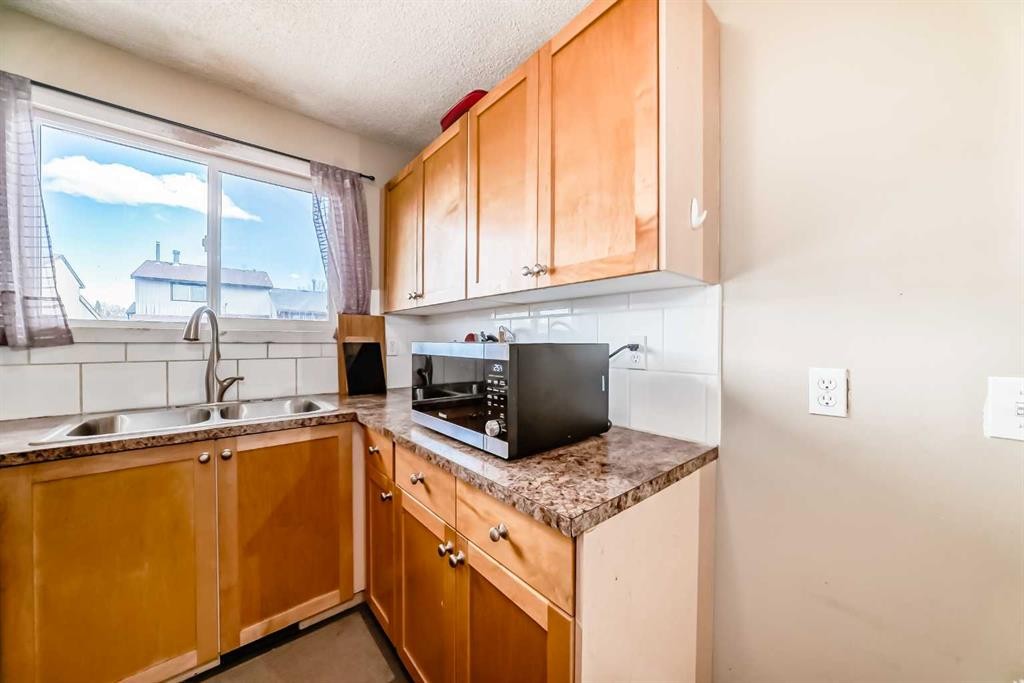 148 Pinemill Mews Ne, Calgary, AB - Indoor Photo Showing Kitchen With Double Sink