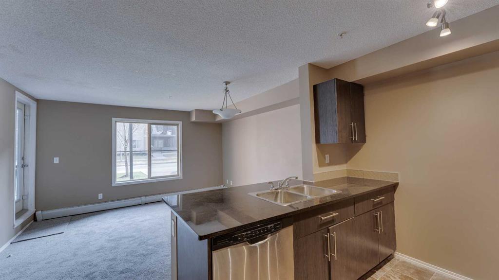 105-2715 12 Avenue Se, Calgary, AB - Indoor Photo Showing Kitchen With Double Sink