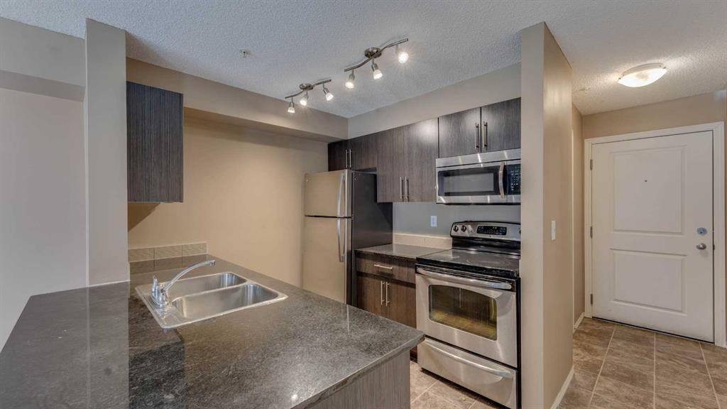 105-2715 12 Avenue Se, Calgary, AB - Indoor Photo Showing Kitchen With Double Sink