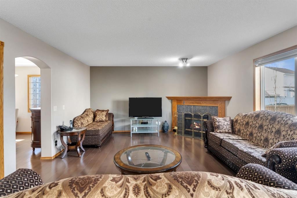 717 Coral Springs Boulevard Ne, Calgary, AB - Indoor Photo Showing Living Room With Fireplace