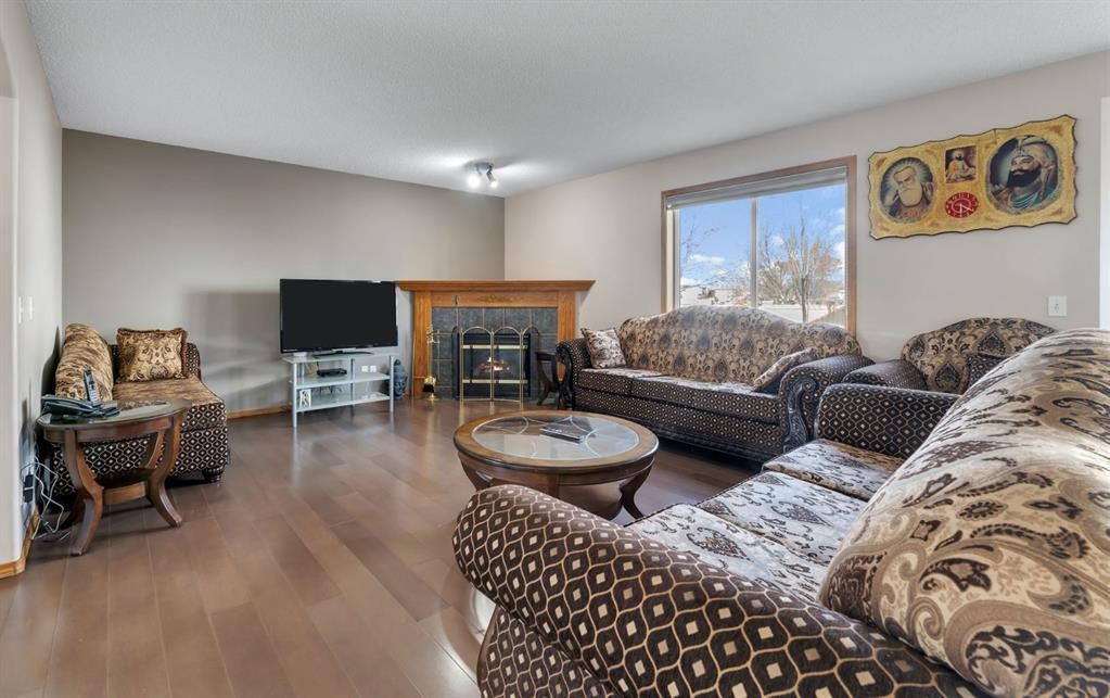717 Coral Springs Boulevard Ne, Calgary, AB - Indoor Photo Showing Living Room With Fireplace