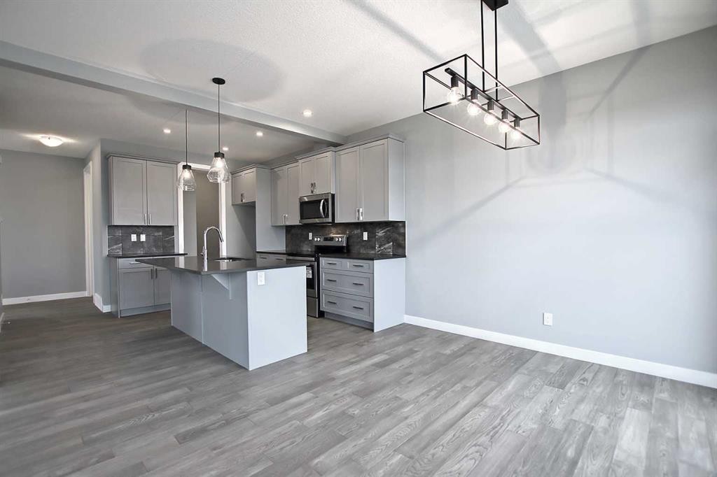 47 Agate Road, Cochrane, AB - Indoor Photo Showing Kitchen With Upgraded Kitchen
