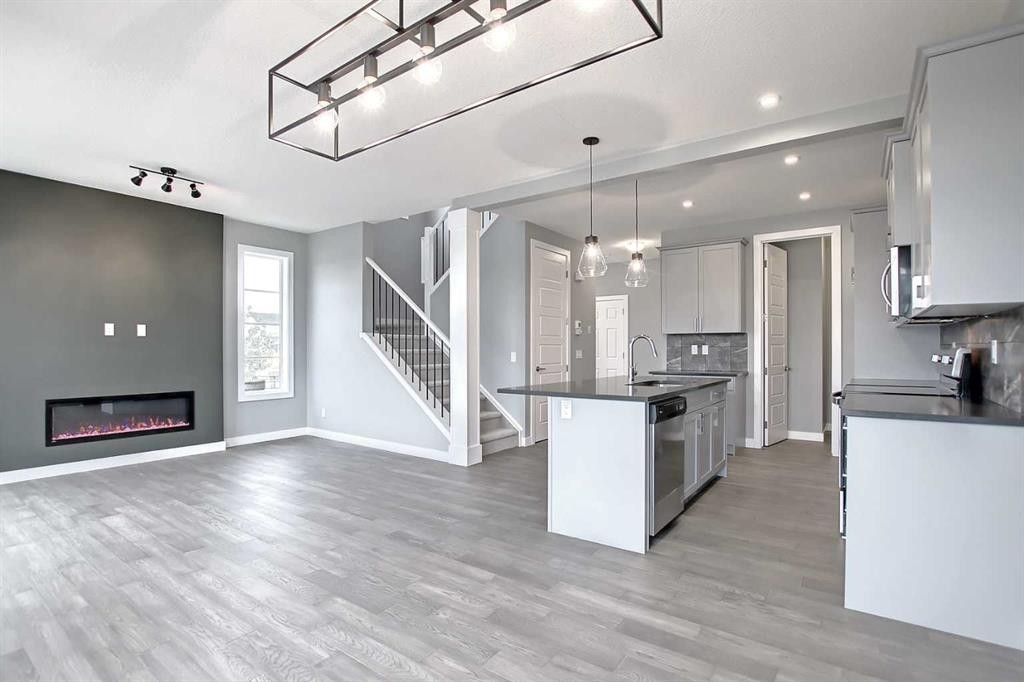 47 Agate Road, Cochrane, AB - Indoor Photo Showing Kitchen With Fireplace