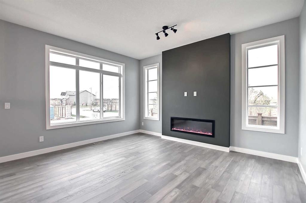 47 Agate Road, Cochrane, AB - Indoor Photo Showing Living Room With Fireplace
