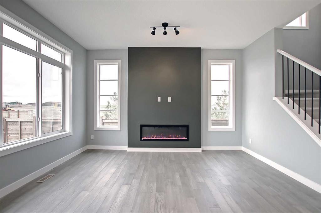 47 Agate Road, Cochrane, AB - Indoor Photo Showing Living Room With Fireplace