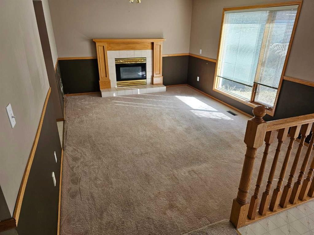 302 Meadowbrook Bay Se, Airdrie, AB - Indoor With Fireplace