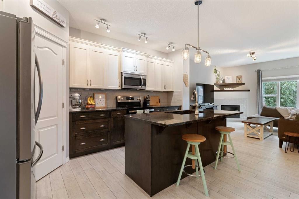 95 Evansborough Common Nw, Calgary, AB - Indoor Photo Showing Kitchen With Fireplace With Upgraded Kitchen