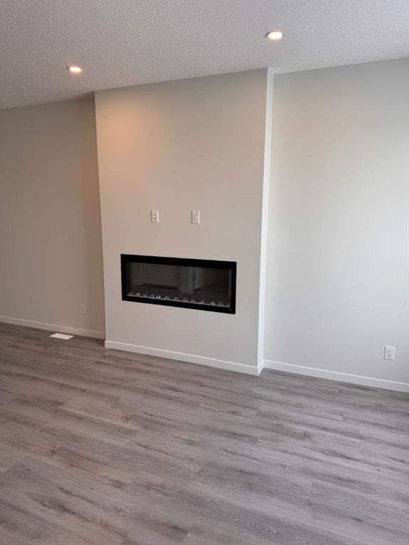 25 Setonvista Gate Se, Calgary, AB - Indoor Photo Showing Living Room With Fireplace
