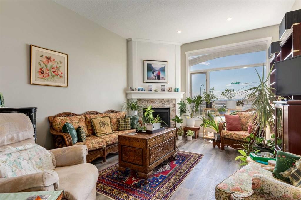 26 Eagleview Way, Cochrane, AB - Indoor Photo Showing Living Room With Fireplace