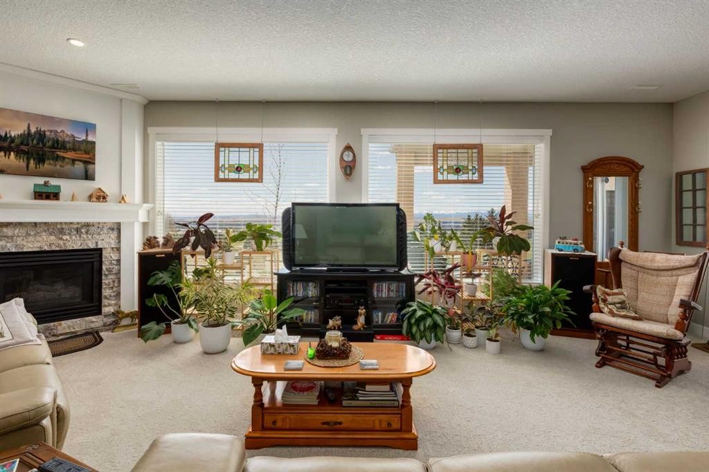 26 Eagleview Way, Cochrane, AB - Indoor Photo Showing Living Room With Fireplace