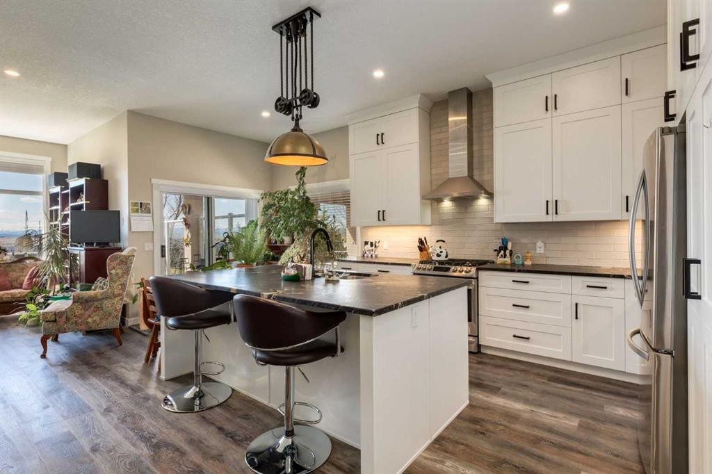 26 Eagleview Way, Cochrane, AB - Indoor Photo Showing Kitchen With Stainless Steel Kitchen With Upgraded Kitchen