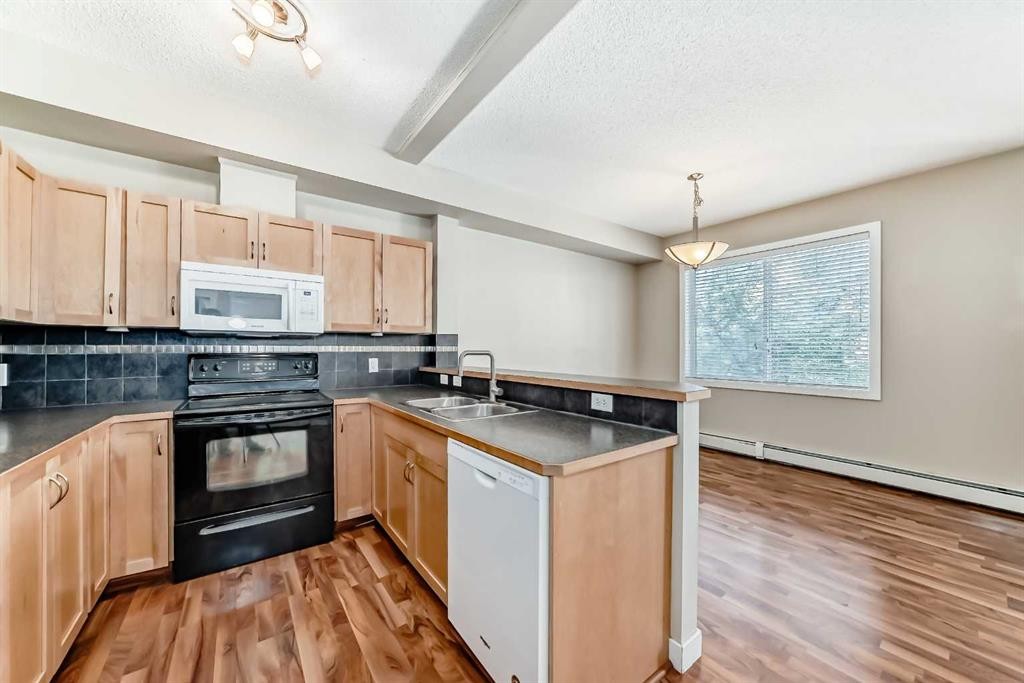 2210-211 Aspen Stone Boulevard Sw, Calgary, AB - Indoor Photo Showing Kitchen With Double Sink