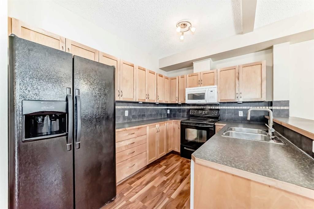 2210-211 Aspen Stone Boulevard Sw, Calgary, AB - Indoor Photo Showing Kitchen With Double Sink