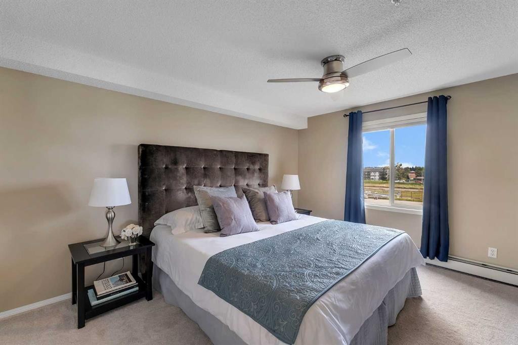 8328-304 Mackenzie Way Sw, Airdrie, AB - Indoor Photo Showing Bedroom