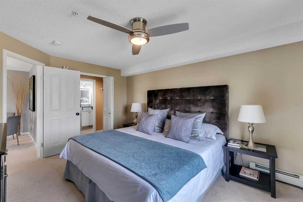 8328-304 Mackenzie Way Sw, Airdrie, AB - Indoor Photo Showing Bedroom