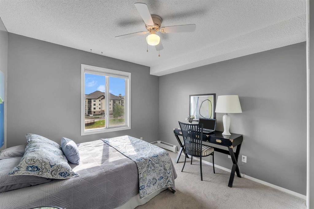 8328-304 Mackenzie Way Sw, Airdrie, AB - Indoor Photo Showing Bedroom