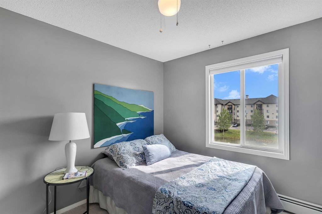 8328-304 Mackenzie Way Sw, Airdrie, AB - Indoor Photo Showing Bedroom