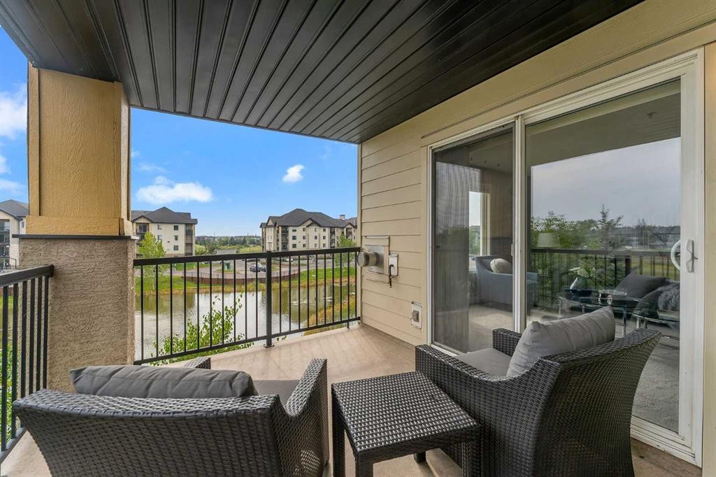 8328-304 Mackenzie Way Sw, Airdrie, AB - Outdoor With Deck Patio Veranda With Exterior