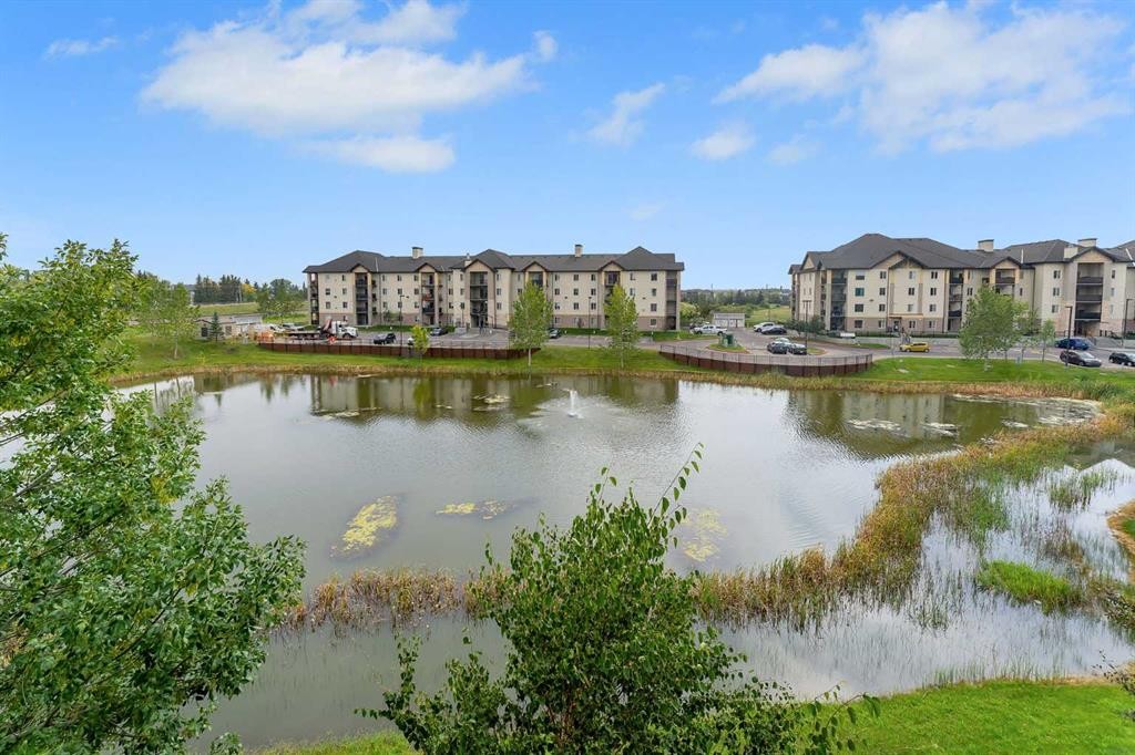 8328-304 Mackenzie Way Sw, Airdrie, AB - Outdoor With Body Of Water With View