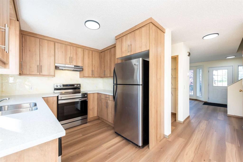 216 Hidden Hills Road Nw, Calgary, AB - Indoor Photo Showing Kitchen With Double Sink