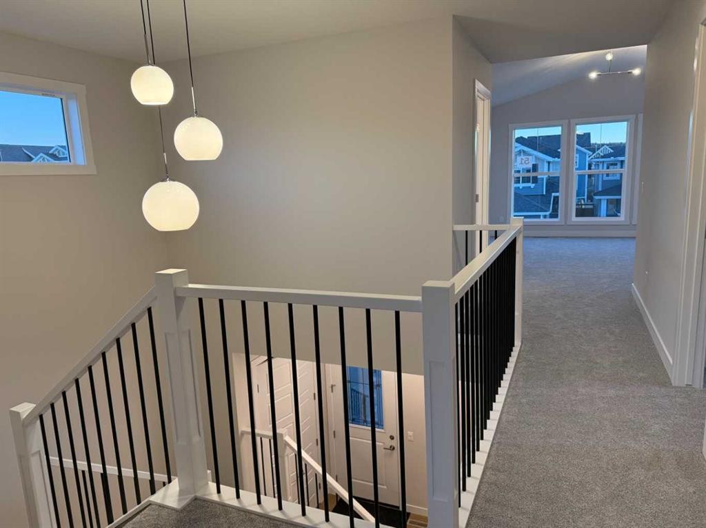 51 Sunrise Heath, Cochrane, AB - Indoor Photo Showing Other Room