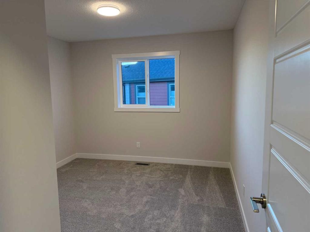 51 Sunrise Heath, Cochrane, AB - Indoor Photo Showing Other Room