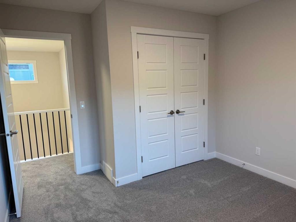 51 Sunrise Heath, Cochrane, AB - Indoor Photo Showing Other Room