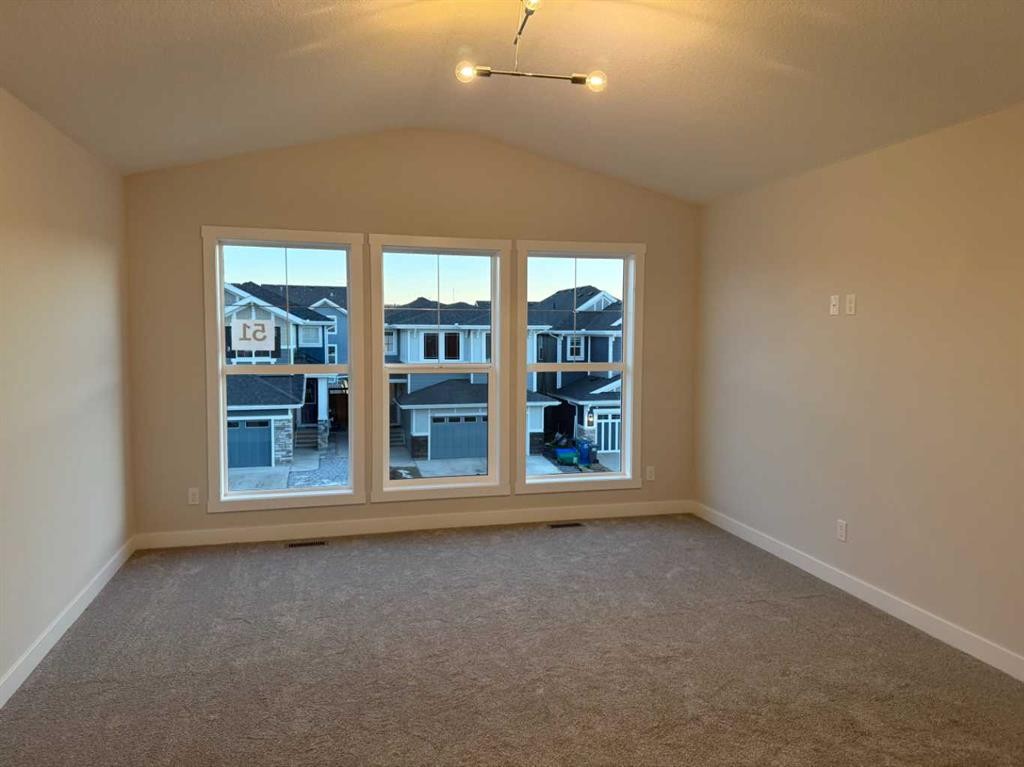 51 Sunrise Heath, Cochrane, AB - Indoor Photo Showing Other Room