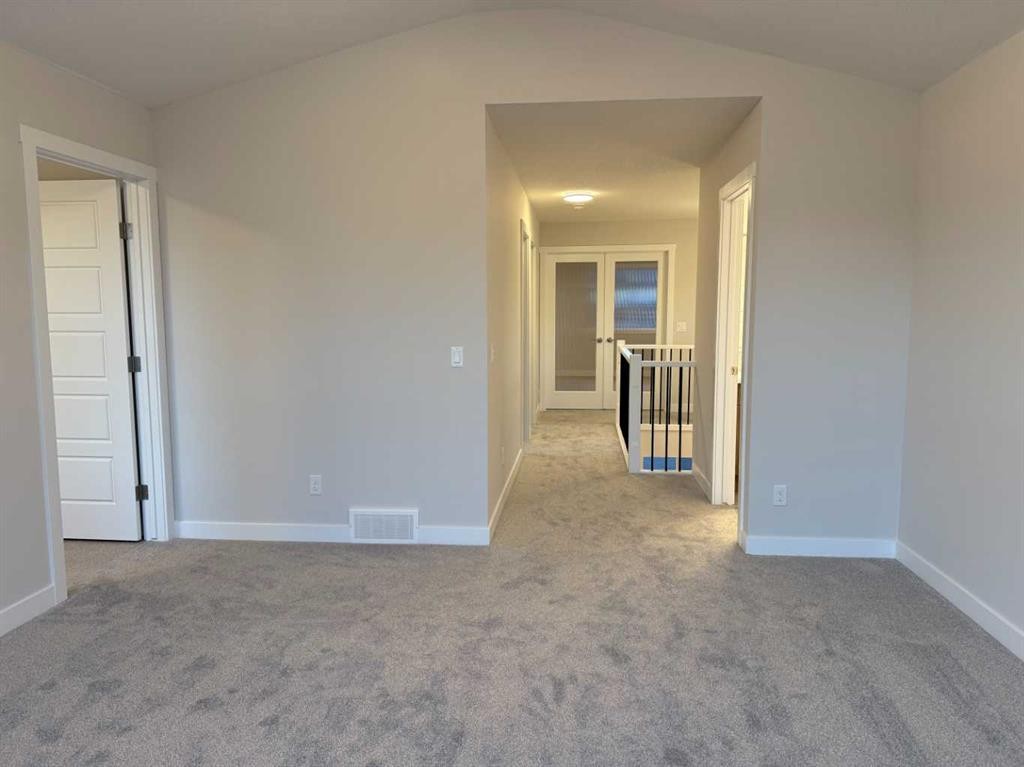 51 Sunrise Heath, Cochrane, AB - Indoor Photo Showing Other Room